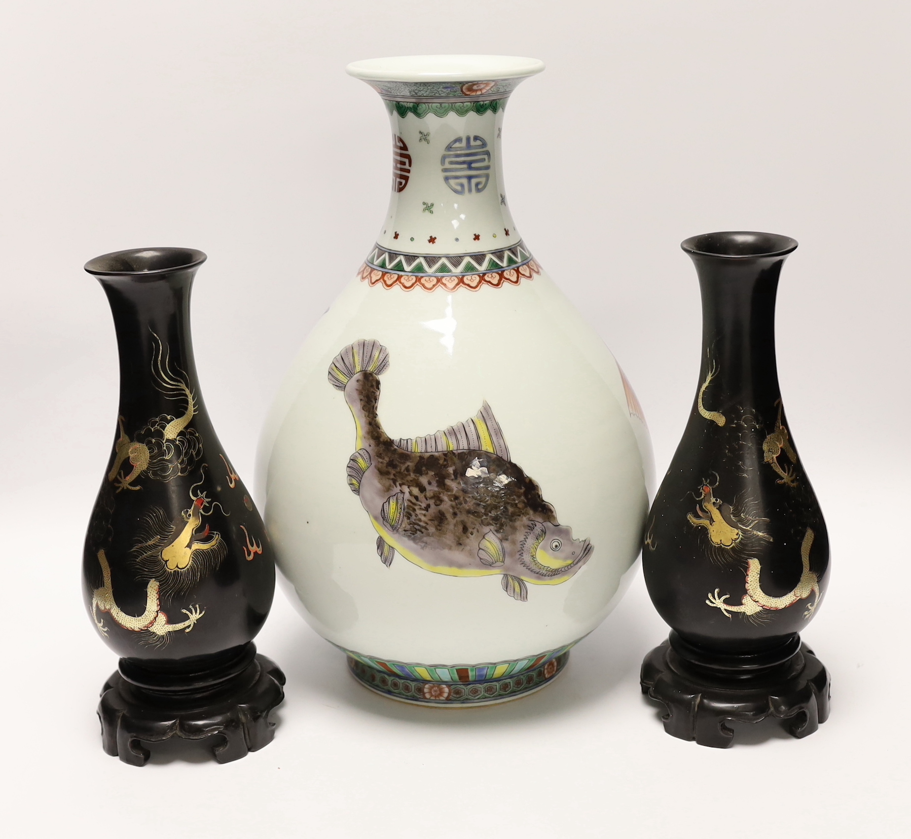 A Chinese porcelain ‘fish’ vase and a pair of Chinese lacquer vases on stands, tallest 33cm